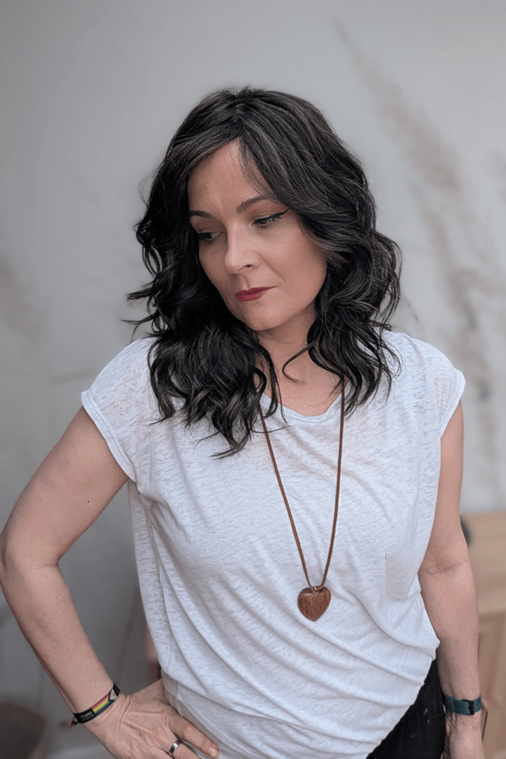 Woman wearing curly shouldar length (Belle Tress' Westwood in Coolest Dark Brown R)