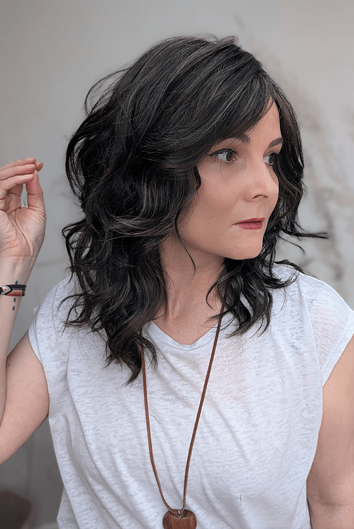 Woman wearing curly shouldar length (Belle Tress' Westwood in Coolest Dark Brown R)