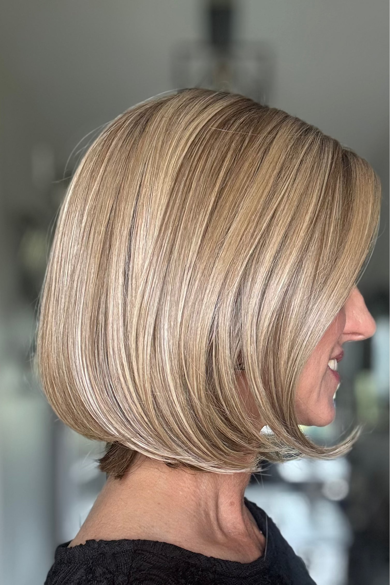 Woman wearing mid-length blonde bob (Bethany by Wig Pro in 12/R8)