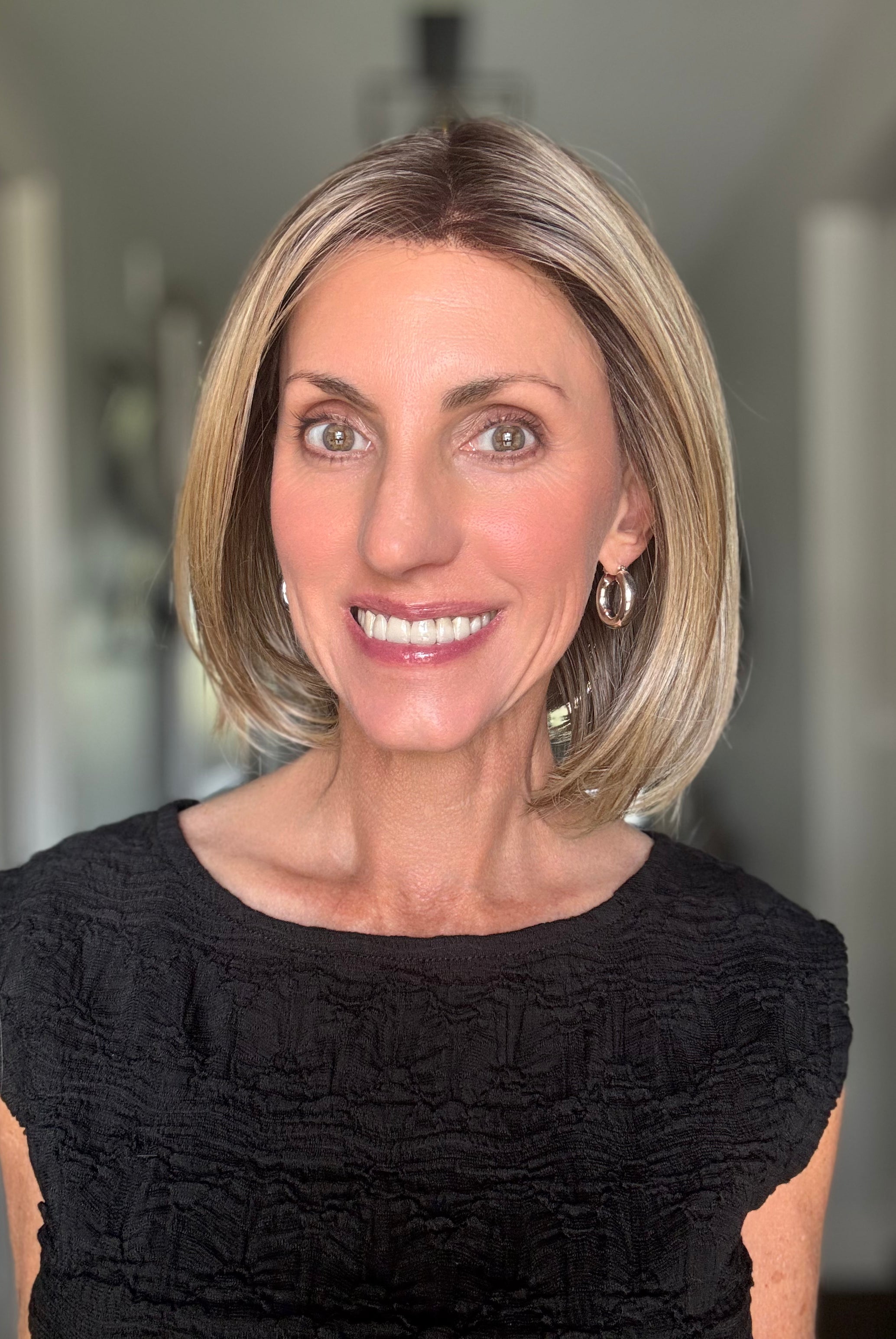 Woman wearing mid-length blonde bob (Bethany by Wig Pro in 12/R8)