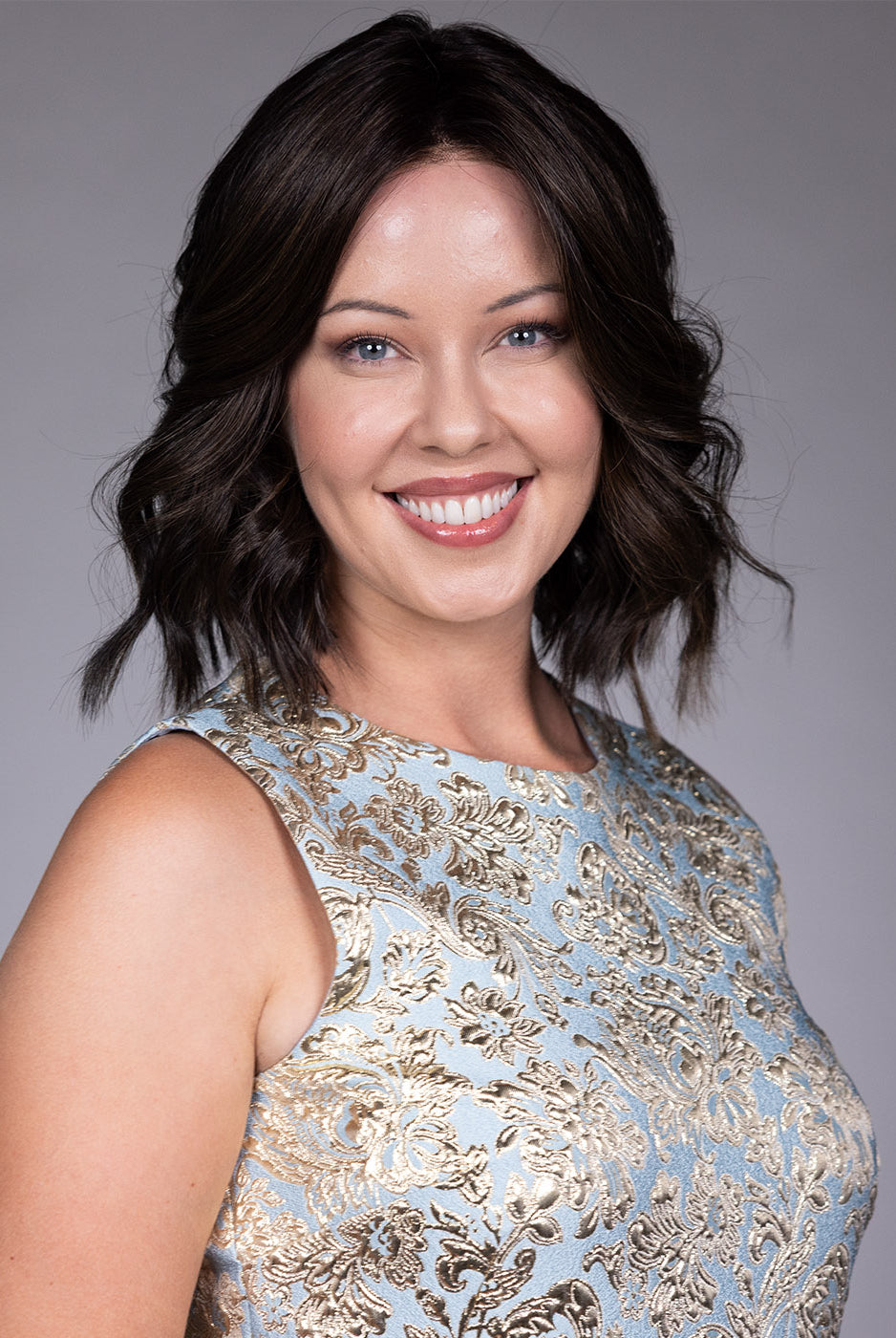 Woman wearing Zurich wig by Belle Tress in Triple Chocolate R | Front smiling