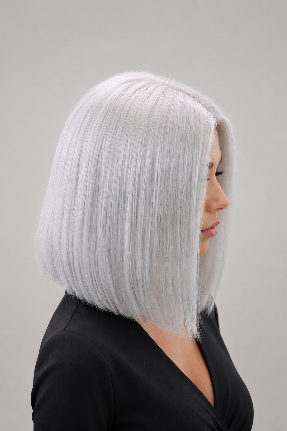Woman wearing Bespoke 12" Human Hair Wig by PUSH in color Blanche against a plain background - Right side view.