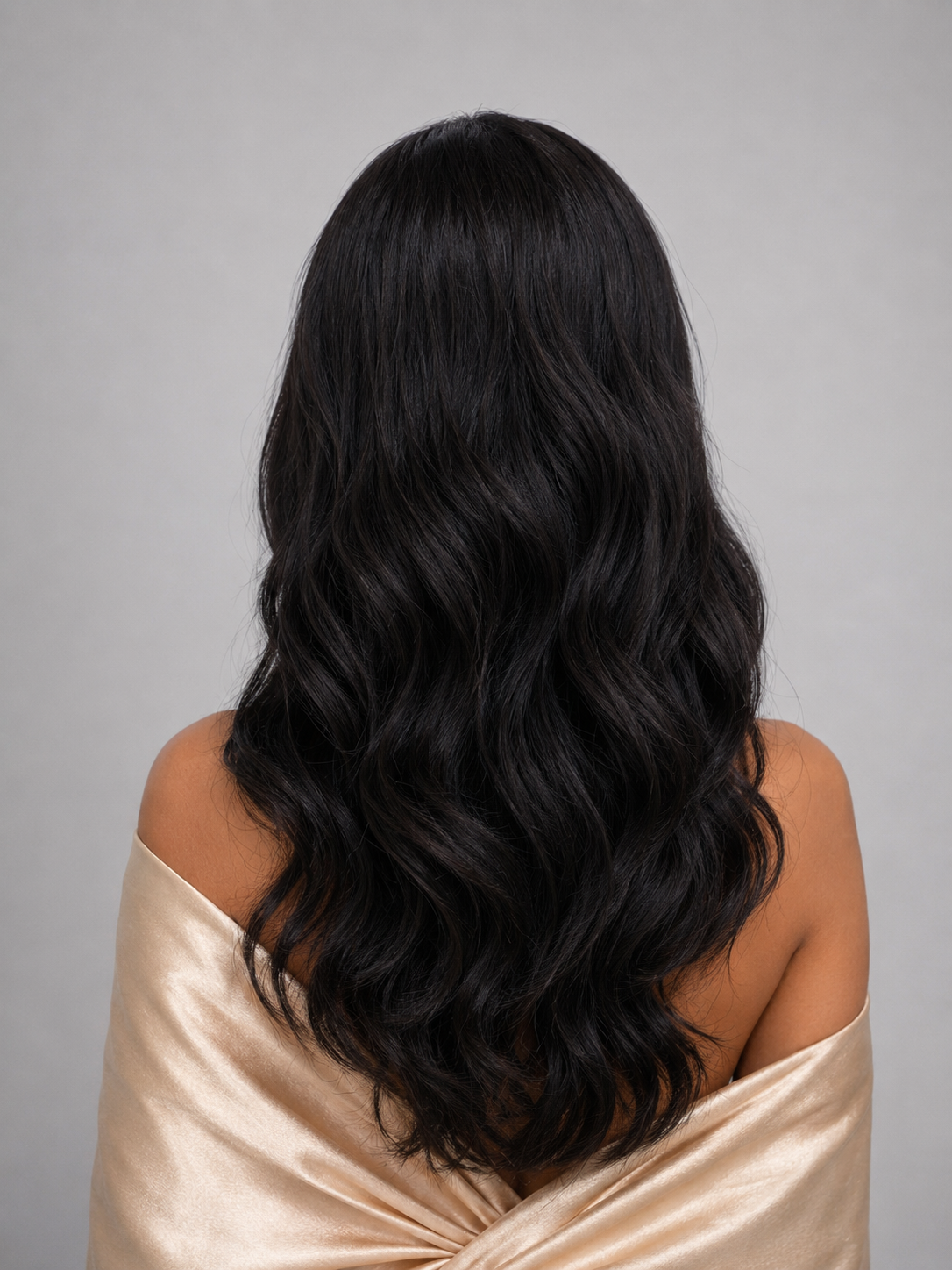 Woman wearing 24" long wavy human hair wig by PUSH Hair in color Noir - Back view.