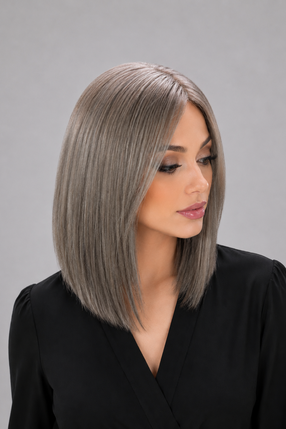 Woman wearing Bespoke human hair wig by PUSH - 16" inverted bob wig in color sage with a black blouse against a light grey background - side view