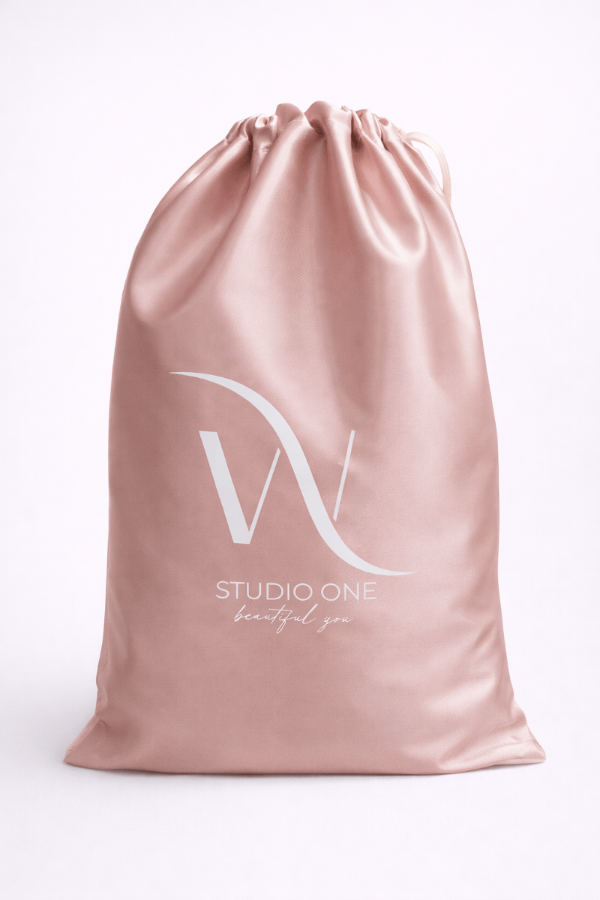 Pink satin drawstring bag with 'Studio One' logo on a white background