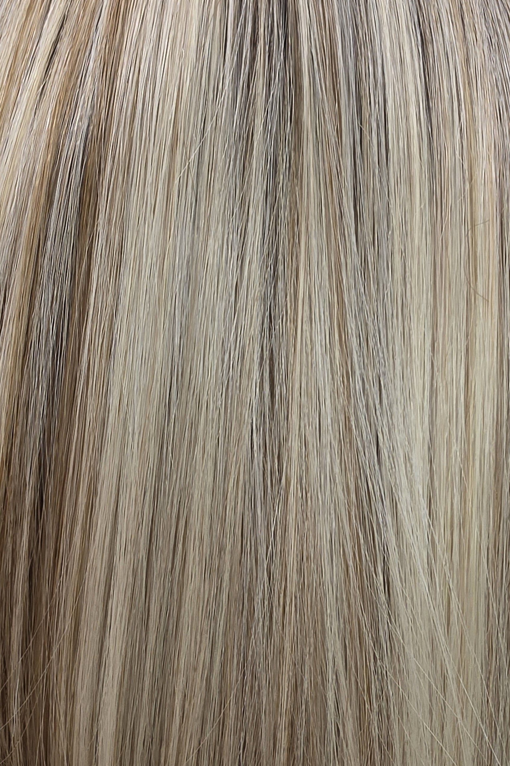 White Champagne Rooted | TT4/1260 | A soft, dimensional neutral blonde with a sophisticated blend of cool and warm tones. Fine ribbons of light beige blonde, white champagne blonde, and pale sandy blonde are blended throughout, with a few slightly warmer honey-beige strands and a light brunette base.