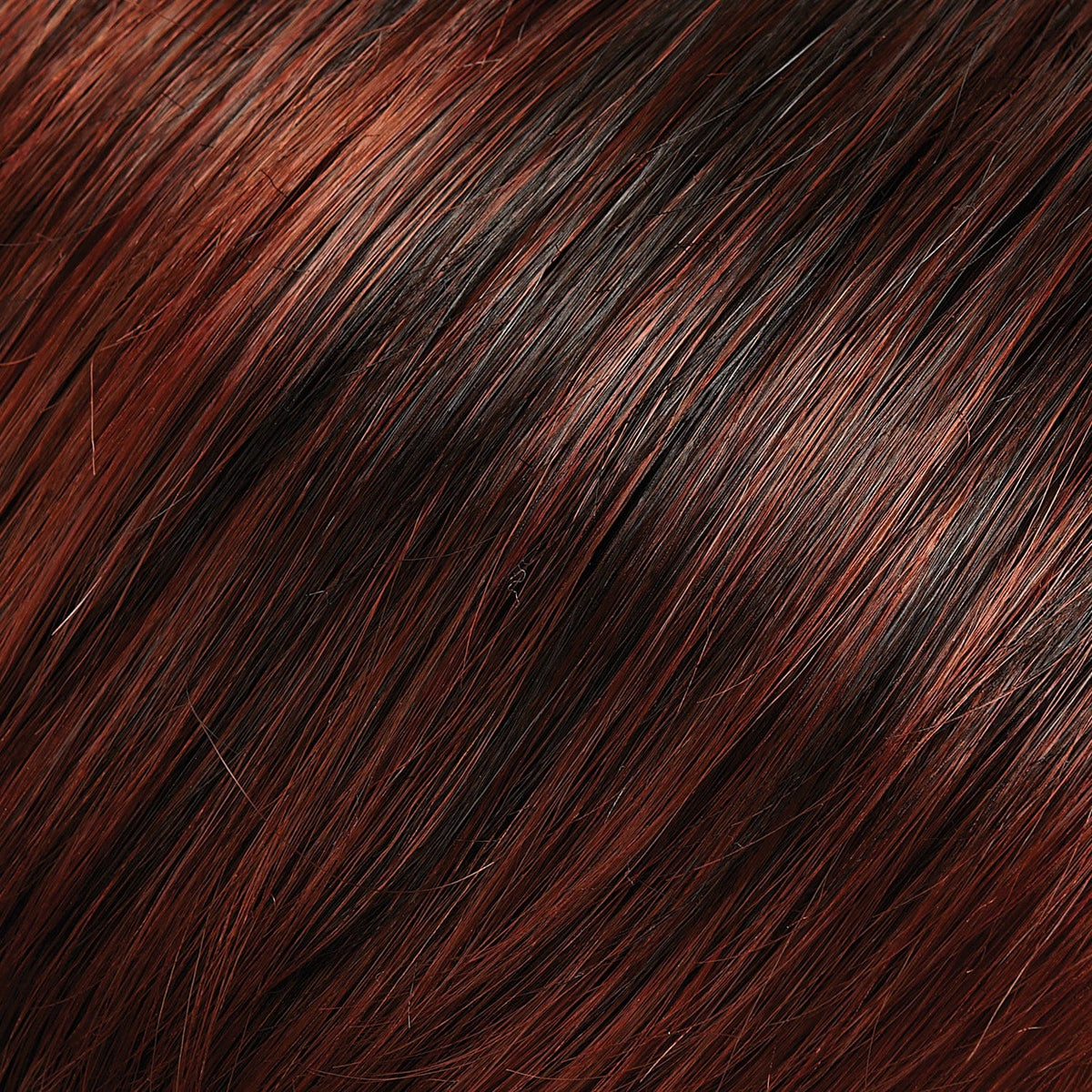Close-up of auburn and black hair strands.