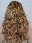 Back of head woman with long, wavy hair wearing a 16-24 inch Bespoke wig from PUSH Hair in color Belle 