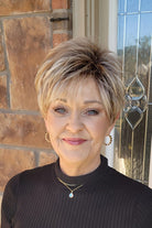 Woman wearing short pixie style (Rin by Noriko in color Seasalt Blonde)