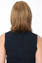 Back view of Amber by Envy synthetic lace front wig, shoulder-length, layered, in a warm amber brown.