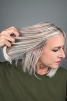 Woman wearing a shoulder length straight blonde bob (Amelie by PUSH Hair in color Roca Margarita Blonde).