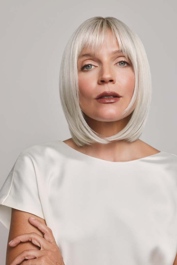 Ami by Noriko synthetic lace front bob wig in a sleek, platinum blonde shade with soft face-framing layers.