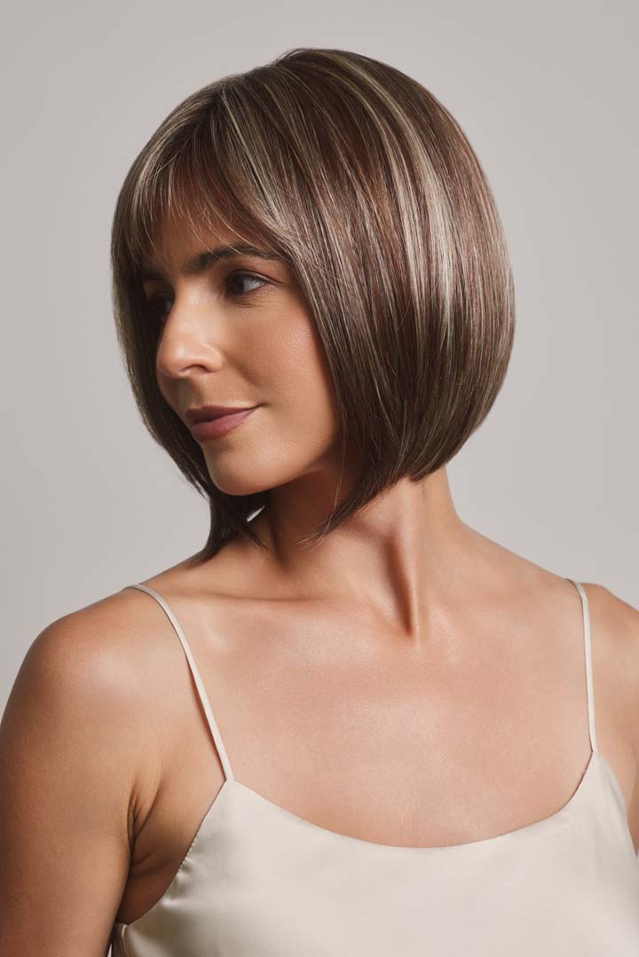 Ami by Noriko medium-length synthetic bob wig with face-framing layers and highlighted brown tones.