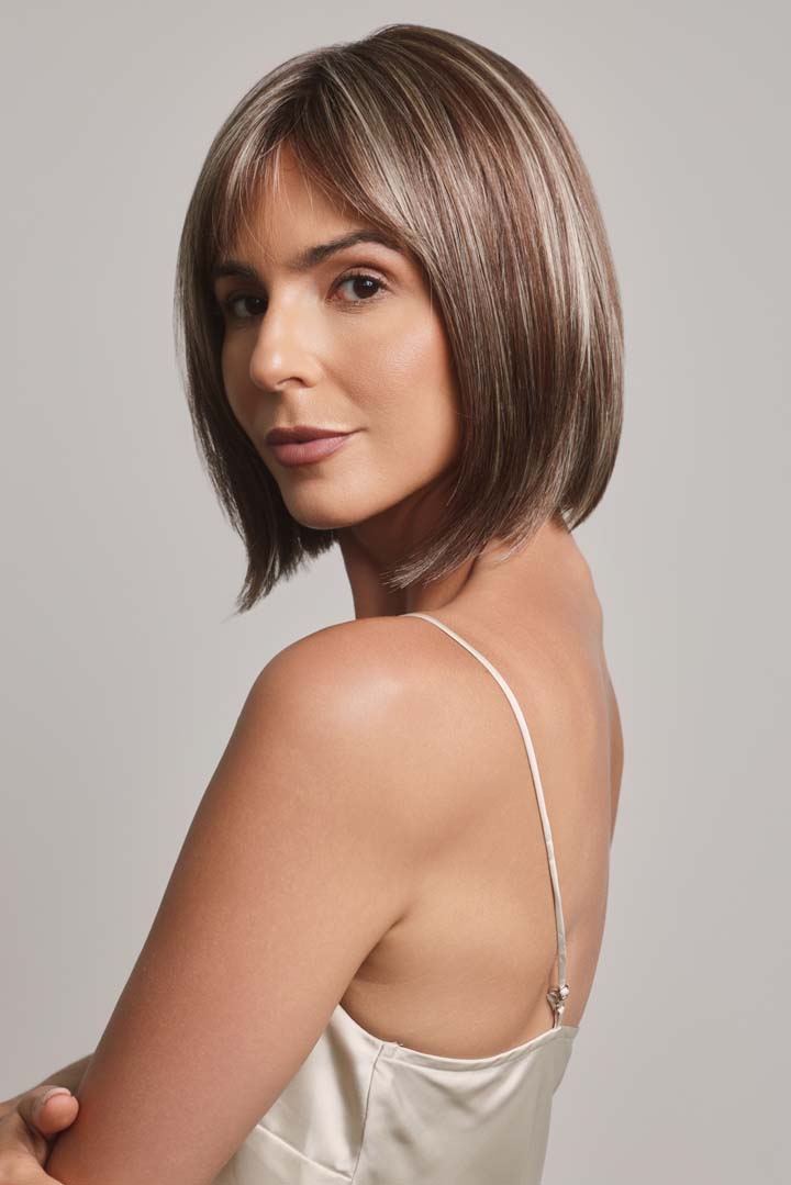 Ami by Noriko synthetic lace front bob wig in a highlighted brown shade with face-framing layers and a mono part.