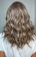 Woman wearing wavy shoulder-length wig (Maude by Amore in Tres Chocolate R)