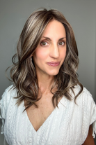 Woman wearing wavy shoulder-length wig (Maude by Amore in Tres Chocolate R)