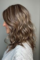 Woman wearing wavy shoulder-length wig (Maude by Amore in Tres Chocolate R)