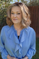 Woman wearing curled shoulder-length wig (Rohan by Amore in color Cinnamon Frost R)