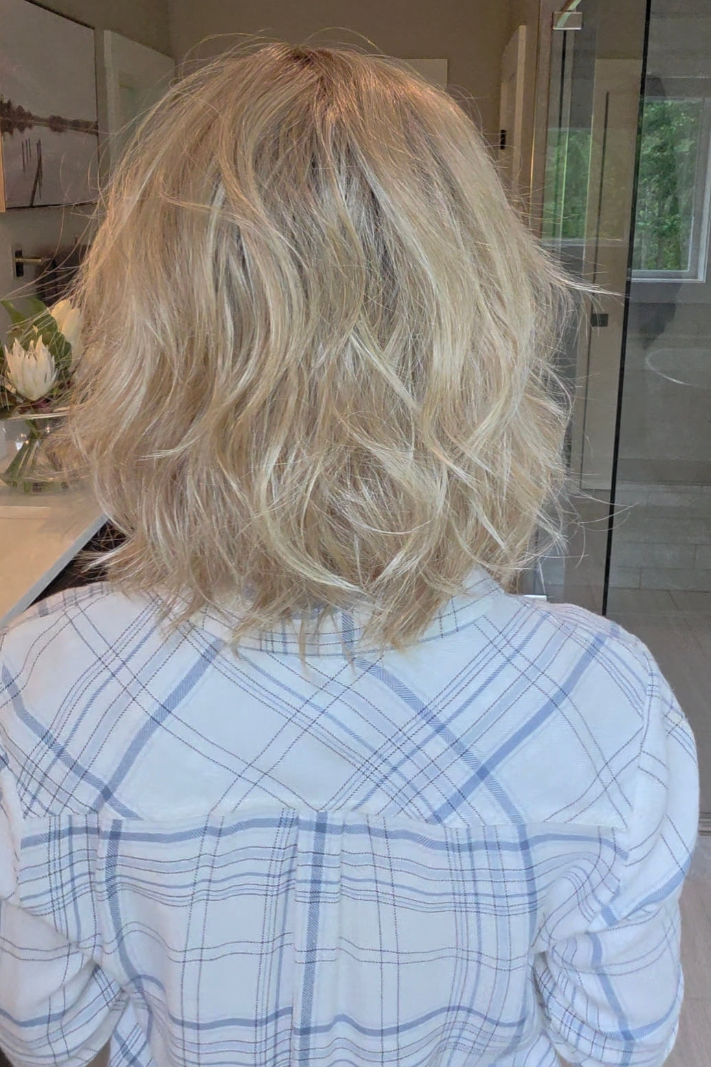 Woman wearing short wavy bob with bangs (Terra by Amore in Rose Gold R).