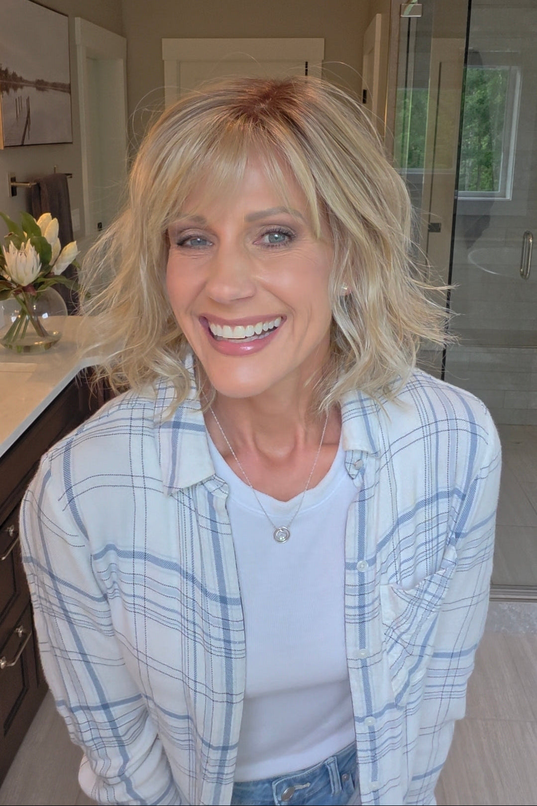 Woman wearing short wavy bob with bangs (Terra by Amore in Rose Gold R).