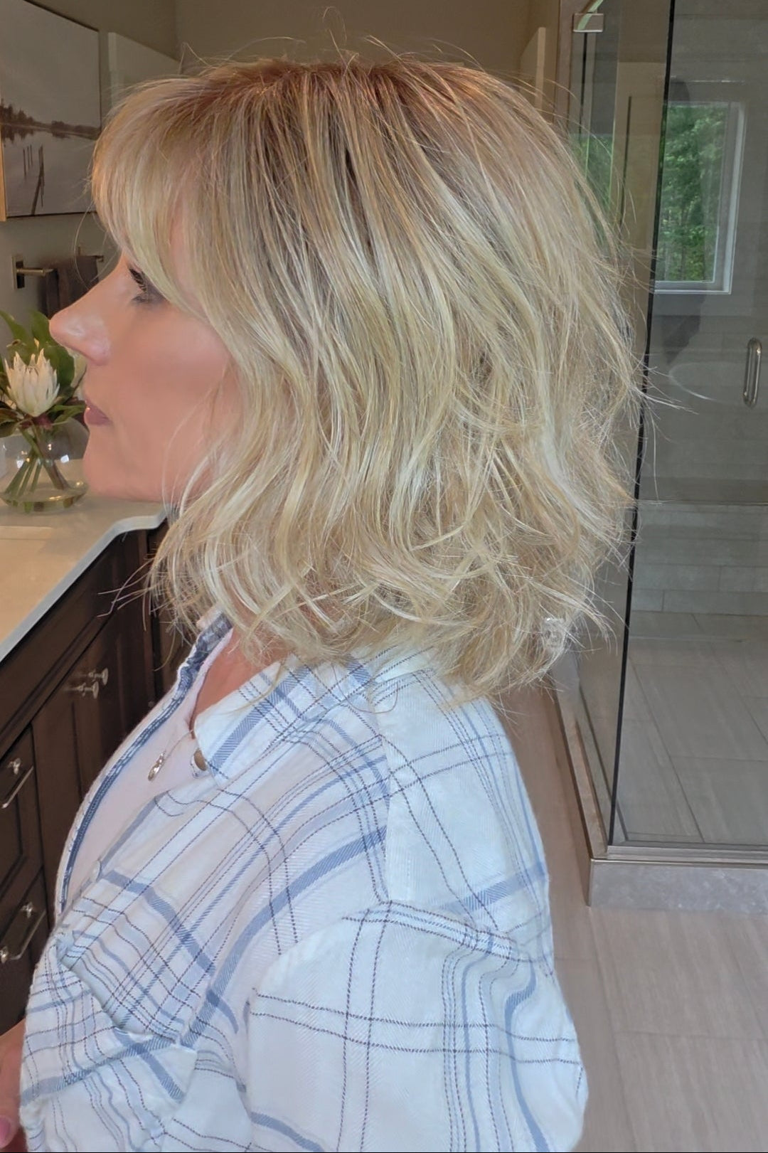 Woman wearing short wavy bob with bangs (Terra by Amore in Rose Gold R).
