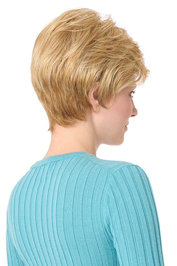 Blonde synthetic Angel by Envy short pixie wig with layered bangs and cropped back on a woman.