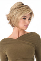 Angie by Envy short, layered blonde synthetic lace front wig with a mono top on a model.