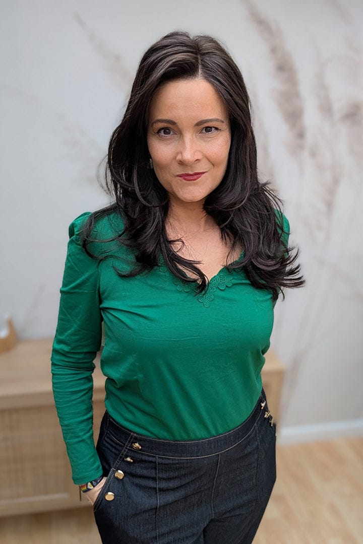 Woman wearing long dark brown layered wavy wig (Henry Margu's Ava in color 4H)