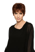 Woman wearing Aubrie synthetic pixie wig by WigPro in color 32/130 wearing a black top against a white background - front view