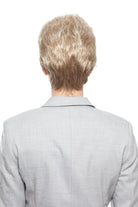 Woman wearing Aubrie synthetic pixie wig by WigPro in color SF23-20-27 wearing a black top against a white background - back view