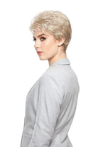 Woman wearing Aubrie synthetic pixie wig by WigPro in color SF23-20-27 wearing a black top against a white background - side view