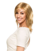 Woman wearing Diane synthetic wig by WigPro in a golden blonde color with a white shirt and white background - Side view