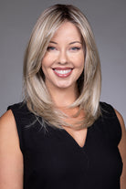 Bailey by Belle Tress mid-length blonde layered synthetic wig with a natural lace front and monofilament top.