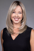Bailey by Belle Tress mid-length blonde layered synthetic wig with a natural lace front and monofilament top.
