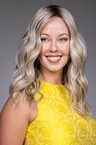 Bella by Belle Tress long blonde wavy heat-friendly synthetic wig with a natural lace front and monofilament top.