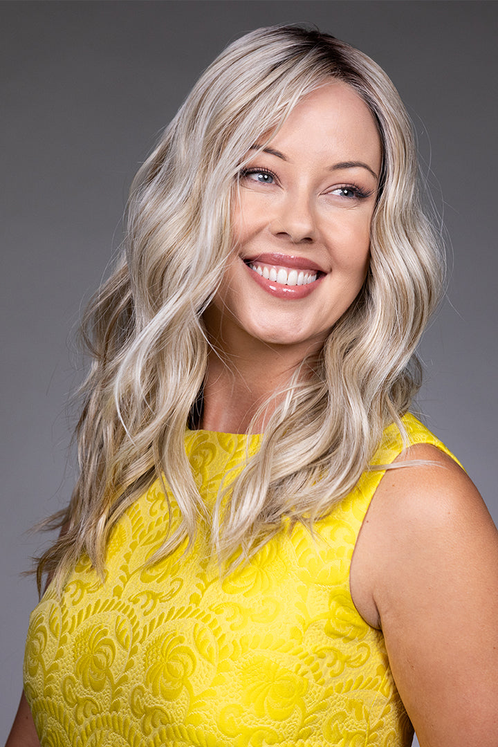 Bella by Belle Tress long blonde wavy synthetic wig with a natural lace front and monofilament top.