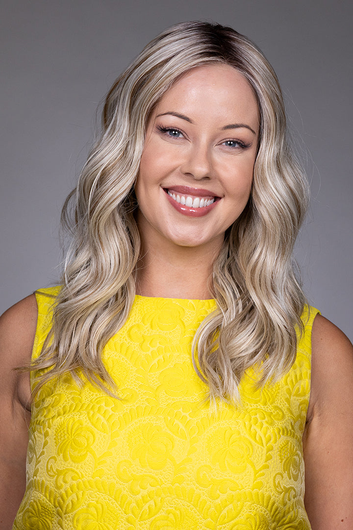 Bella by Belle Tress long wavy blonde synthetic wig with a natural lace front and monofilament top.