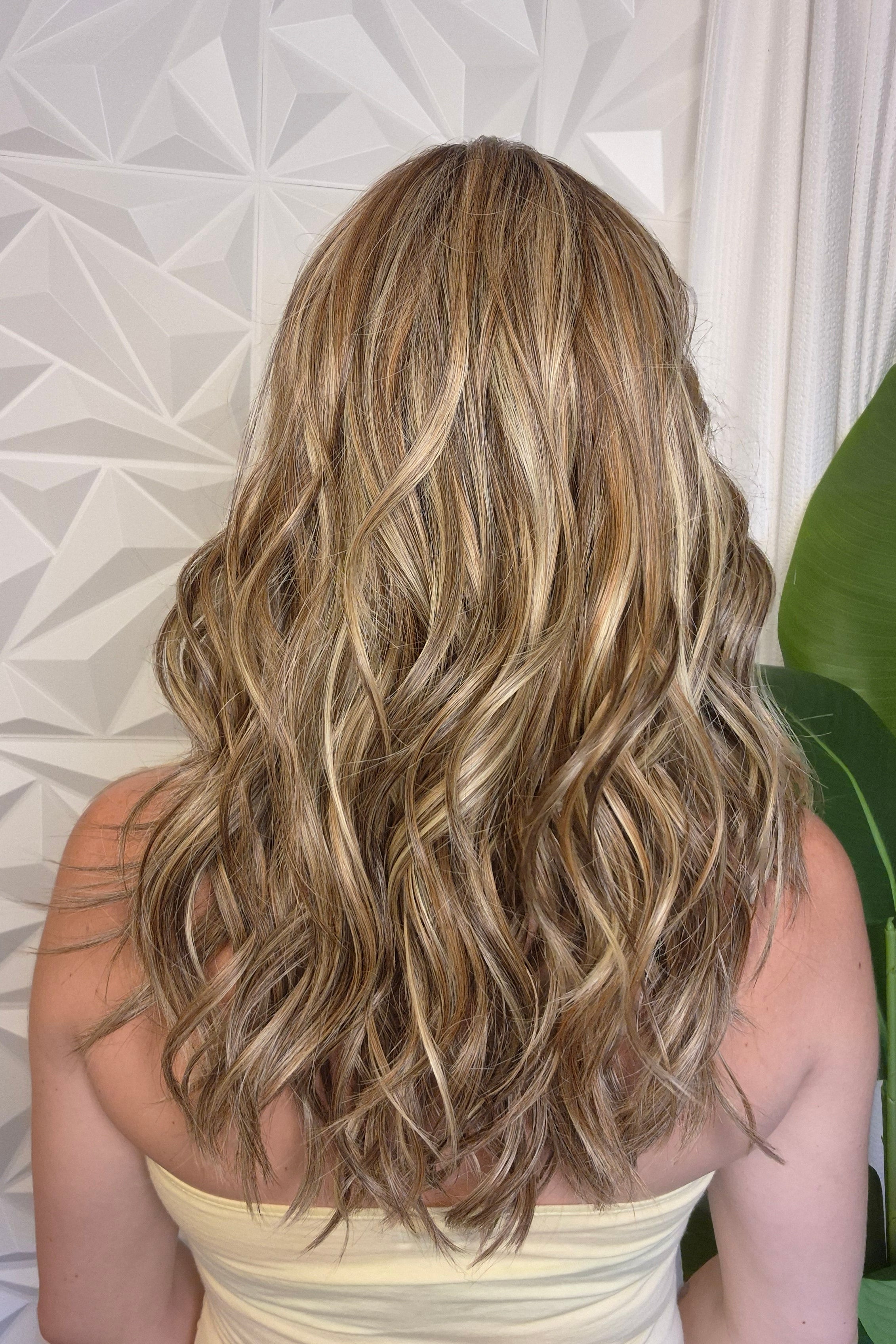 A woman with wavy blonde and brown hair wearing a pale yellow strapless top (wearing Bella by Belle Tress in color Brown Sugar Cookie R).