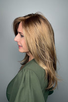 Woman wearing long layered bronde wig (Belinda Hand-Tied by Envy in Mocha Frost).