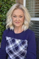 A woman wearing shoulder-length blonde wig with barrel curls (Zurich by Belle Tress in color Alpine Cream R). 