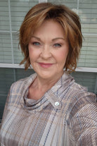 Woman with reddish-brown chin-length bob wig (Marni by Belle Tress in Butter Pecan)