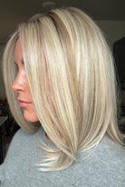 A woman with shoulder-length blonde wig (Adriana by Belle Tress in color Butterbeer Blonde)