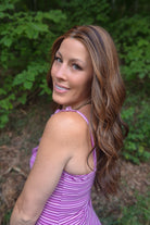 Woman wearing extra long wavy brunette wig (Bradley by PUSH Hair in color Sunlit Brunette).