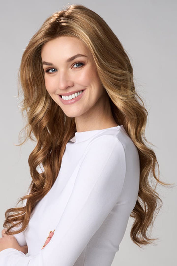 Woman wearing Brianna Hand Tied Wig by Envy in Golden Nutmeg | Front smiling over shoulder