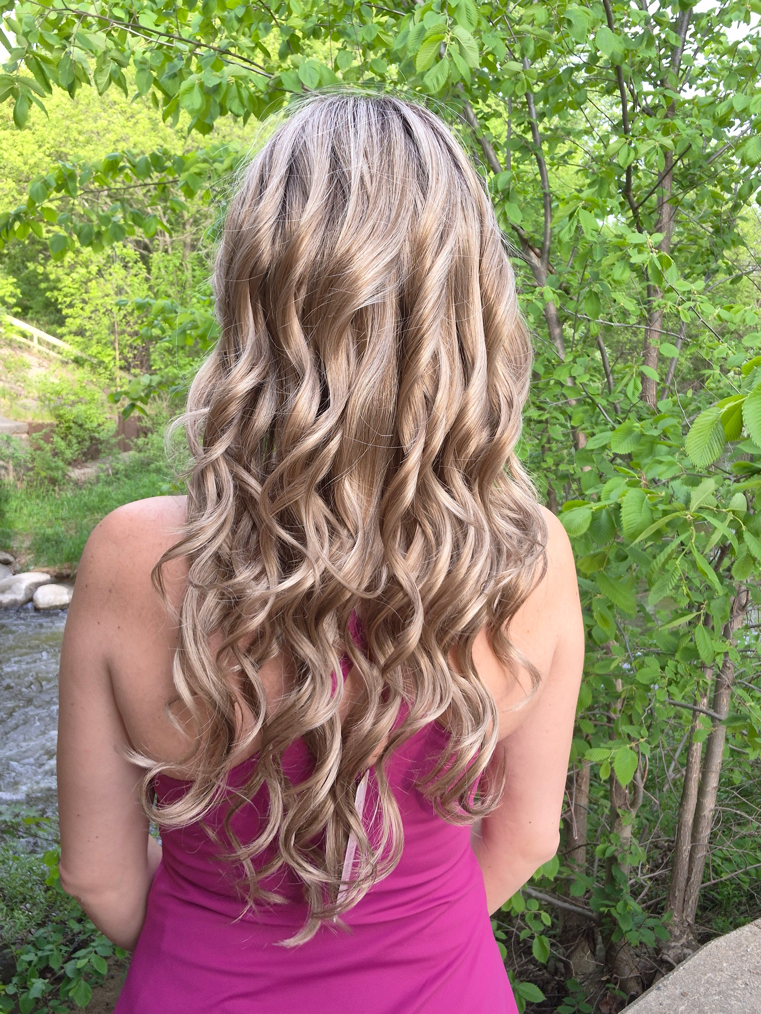 Woman wearing long layered wig with beachy waves (Brianna Hand-Tied in Prosecco).