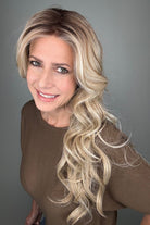 Woman wearing long curly rooted blonde wig (Carolina by Belle Tress in Rootbeer R).