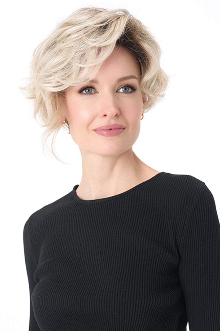 Carrisa by Envy synthetic curly blonde wig with a natural lace front and monofilament part for a realistic look.