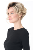 Carrisa by Envy short blonde curly synthetic wig with a lace front and natural monofilament part.