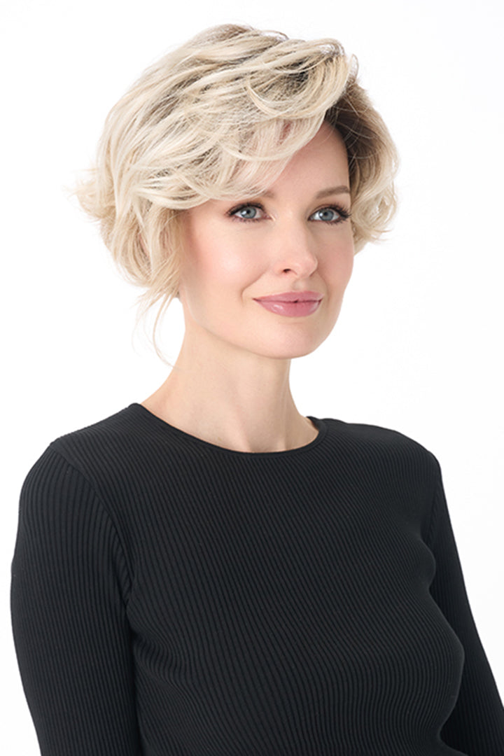 Carrisa by Envy short blonde curly synthetic wig with a natural lace front and monofilament part.