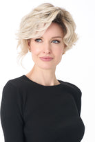 Model wearing a blonde, short-length curly synthetic wig with a natural lace front and monofilament part.